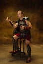 Comic portrait of medieval person, young man, warrior or knight in war equipment isolated on vintage dark background Royalty Free Stock Photo