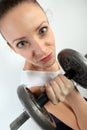 Comic portrait of a woman holding a big dumpbell for weight lifting workout