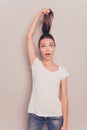 Comic portrait of young girl showing her hair tail Royalty Free Stock Photo