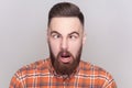 Comic positive bearded man looking cross-eyed, having fun with silly face expression, playing fool. Royalty Free Stock Photo