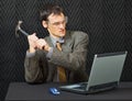 Comical person break computer with hammer Royalty Free Stock Photo