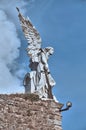 04-09-2012 Comillas, Spain - Winged Angel Sculpture with Sword in Comillas Cemetery