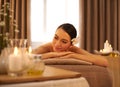 Coming back to me. A beautiful young woman relaxing on a massage table before her massage. Royalty Free Stock Photo