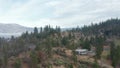 Coming down in front of mountain cliff with houses on the edges in Ashland