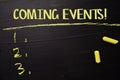 Coming Events! written with color chalk. Supported by an additional services. Blackboard concept Royalty Free Stock Photo