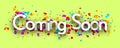 Coming soon with colorful cut out ribbon confetti on green background