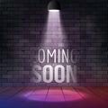 Coming soon message illuminated with light spotlight projector. Brick wall and stage realistic vector Royalty Free Stock Photo