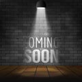 Coming soon message illuminated with light spotlight projector. Brick wall and stage realistic vector Royalty Free Stock Photo