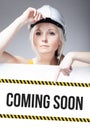 Coming soon sign on template board, worker woman Royalty Free Stock Photo