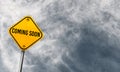 Coming soon - yellow sign with cloudy sky Royalty Free Stock Photo