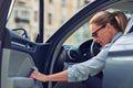 Coming to office. Caucasian middle aged business woman wearing eyeglasses getting out of her modern car, she is arrived Royalty Free Stock Photo