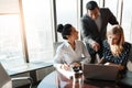 Coming together to decide on their best plans. a group of businesspeople working together on a laptop in an office. Royalty Free Stock Photo