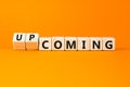 Coming or upcoming symbol. Concept words Coming and Upcoming on wooden cubes. Beautiful orange table orange background. Business Royalty Free Stock Photo