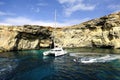 Catamaran at anchor below the cliffs of Comino