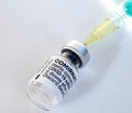 Macro of Comirnaty vaccination ampoule with a syringe against Covid-19 or Corona virus Royalty Free Stock Photo