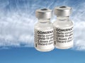 Comirnaty Biontech Pfizer vaccination ampoules against Covid-19 or Corona virus with sky background