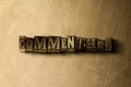 COMMENTARY - close-up of grungy vintage typeset word on metal backdrop