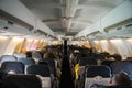 Commercial aircraft cabin with rows of seats down the aisle