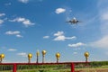 Commercial aircraft flying near clouds and landing with blue sky and landing lights. Travel or business trip concept image. Royalty Free Stock Photo