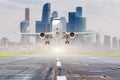 Commercial aircraft jetliner approaching for landing on runway, modern city on background. Royalty Free Stock Photo