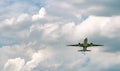 Commercial airline flying on blue sky and white fluffy clouds. Under view of airplane flying. Passenger plane after take off or Royalty Free Stock Photo