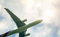 Commercial airline flying on blue sky and white fluffy clouds. Under view of airplane flying. Passenger plane after take off or Royalty Free Stock Photo