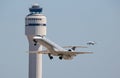 Commercial Airliners Taking Off and Landing with Control Tower Royalty Free Stock Photo