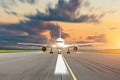 Commercial airplane accelerates on runway airport at sunset at a speed motion blur. Royalty Free Stock Photo