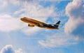Commercial Airplane in Flight Behind Blue Skies