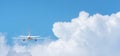 Commercial airplane flying above clouds on day light, Clear blue sky and fluffy soft white cloud with copy space
