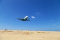 Commercial airplane landing above sea and clear blue sky over beautiful scenery nature background location at mai khao beach Royalty Free Stock Photo