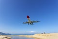 Commercial airplane landing above sea and clear blue sky over beautiful scenery nature background location at mai khao beach Royalty Free Stock Photo