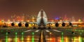 Commercial airplane landing at sunset hours in Asia, telephoto lens. Royalty Free Stock Photo