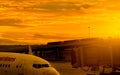 Commercial airplane parked at jet bridge for passenger take off at the airport. Aircraft passenger boarding bridge docked with Royalty Free Stock Photo