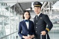 Commercial cabin crew or hostress and pilot occupation concepts. Portrait of Asian airliner pilot and air hostess standing