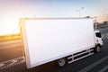 Commercial cargo delivery truck with blank white trailer driving on highway. Royalty Free Stock Photo