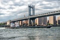 Commercial cargo vessel ship at Eat River in New York City under Manhattan Bridge Royalty Free Stock Photo