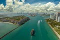 Commercial container ship entering Miami port harbor through main channel near South Beach. Luxurious hotels and Royalty Free Stock Photo