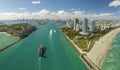 Commercial container ship entering Miami port harbor through main channel near South Beach. Luxurious hotels and Royalty Free Stock Photo