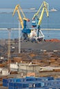 Commercial dock with huge cranes and metal storage Royalty Free Stock Photo