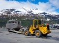 A commercial fishing boat being towed by tractor to a launching ramp in alaska