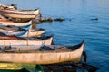 Commercial fishing boats rest on the shore by blue sea