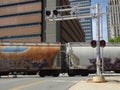 Commercial Freight Train Crosses Over Road at a Railroad Crossing