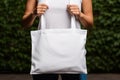 Woman hands holding white blank with copy space bag Royalty Free Stock Photo