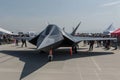 A commercial jet aircraft is stationary on top of the tarmac at an airport, Unveiling of a new stealth fighter aircraft at an Royalty Free Stock Photo