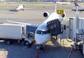 Commercial jet aircraft on tarmac loading its cargo at airport Royalty Free Stock Photo