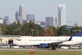 Commercial Jet on Runway with City Skyline Royalty Free Stock Photo