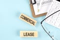 COMMERCIAL LEASE text written on wooden block with clipboard ,eye glasses and calculator Business concept Royalty Free Stock Photo