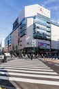 Commercial modern building with crosswalk below and walking people on the road in Sapporo in Hokkaido, Japan
