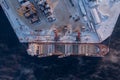 Commercial north arctic port is loading containers onto cargo tanker ship. Concept logistics and delivery of goods Royalty Free Stock Photo